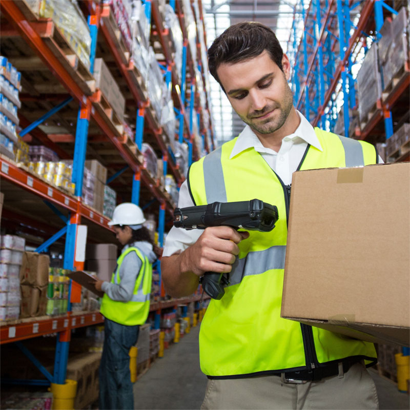 Warehouse workers picking stock with handheld barcode scanners