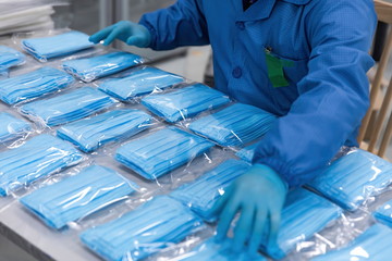 Face masks being produced in volume on a manufacturing line